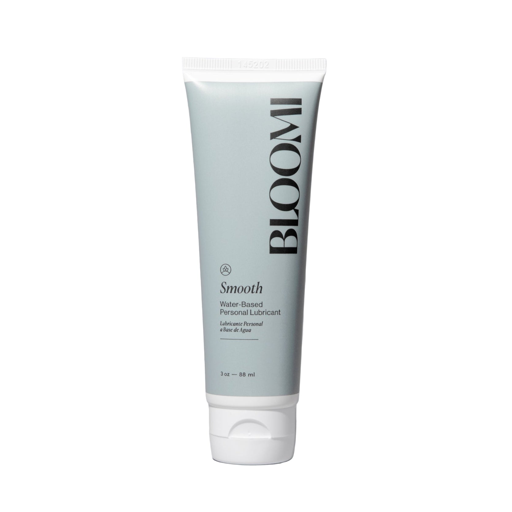 Tube of BLOOMI smooth water-based personal lubricant on a gray background